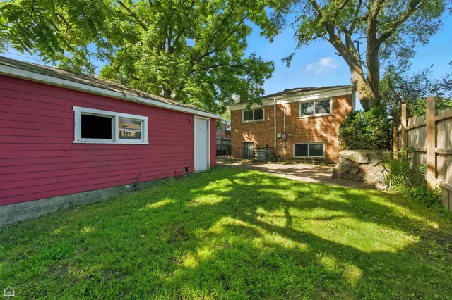 a backyard of a house with yard and outdoor seating