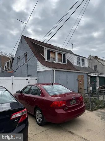 a front view of a house with parking space