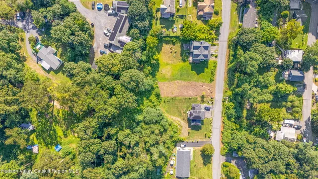 an aerial view of a house with a yard basket ball court and outdoor seating