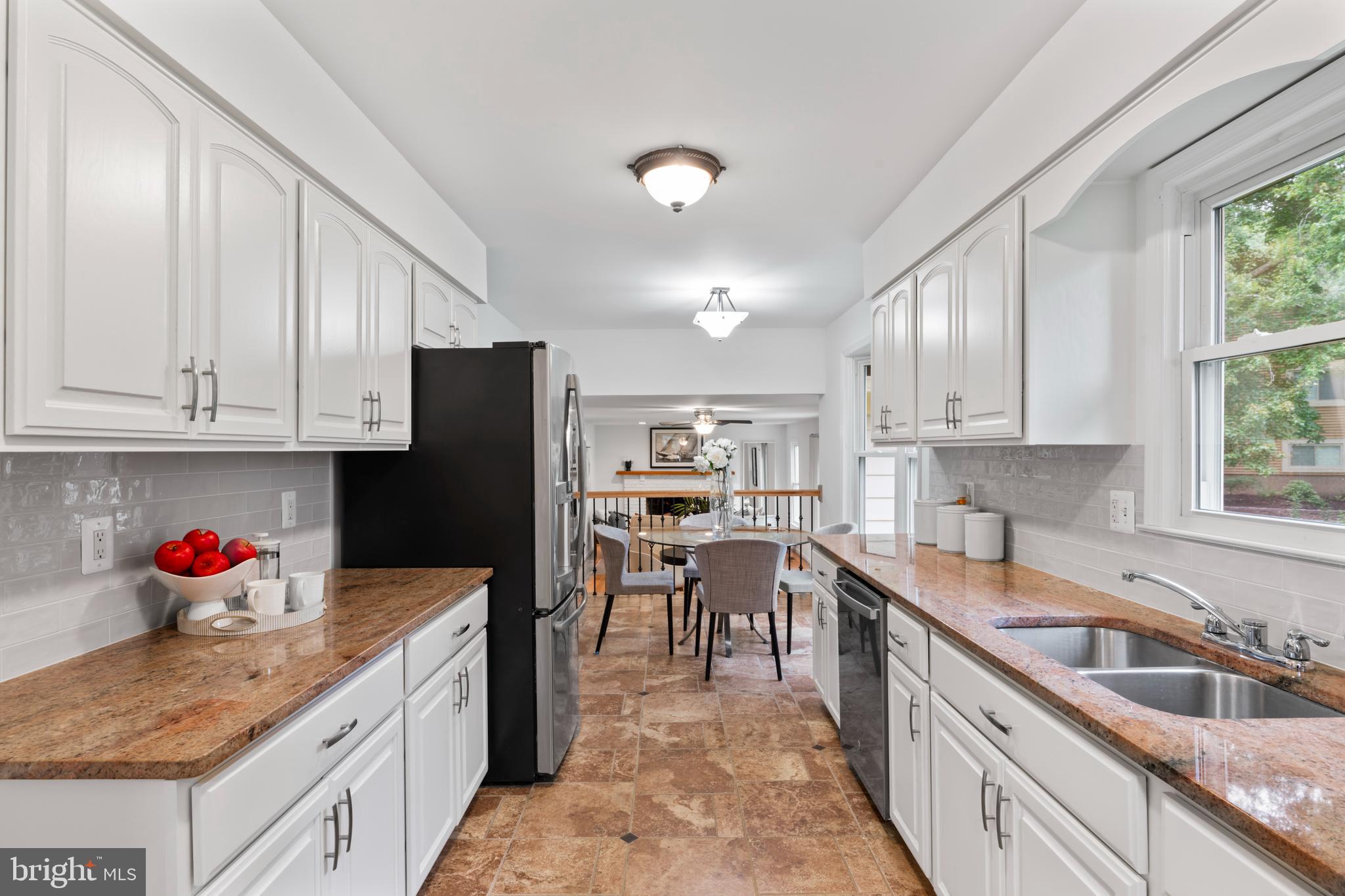 1950 Weybridge Lane Reston, VA 20191 - Photo 14 of 71 a kitchen with granite countertop a sink dishwasher stove and cabinets