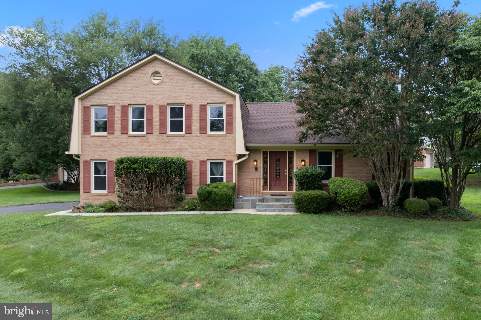 1950 Weybridge Lane Reston, VA 20191 - Photo 4 of 71 a front view of a house with a yard and garage