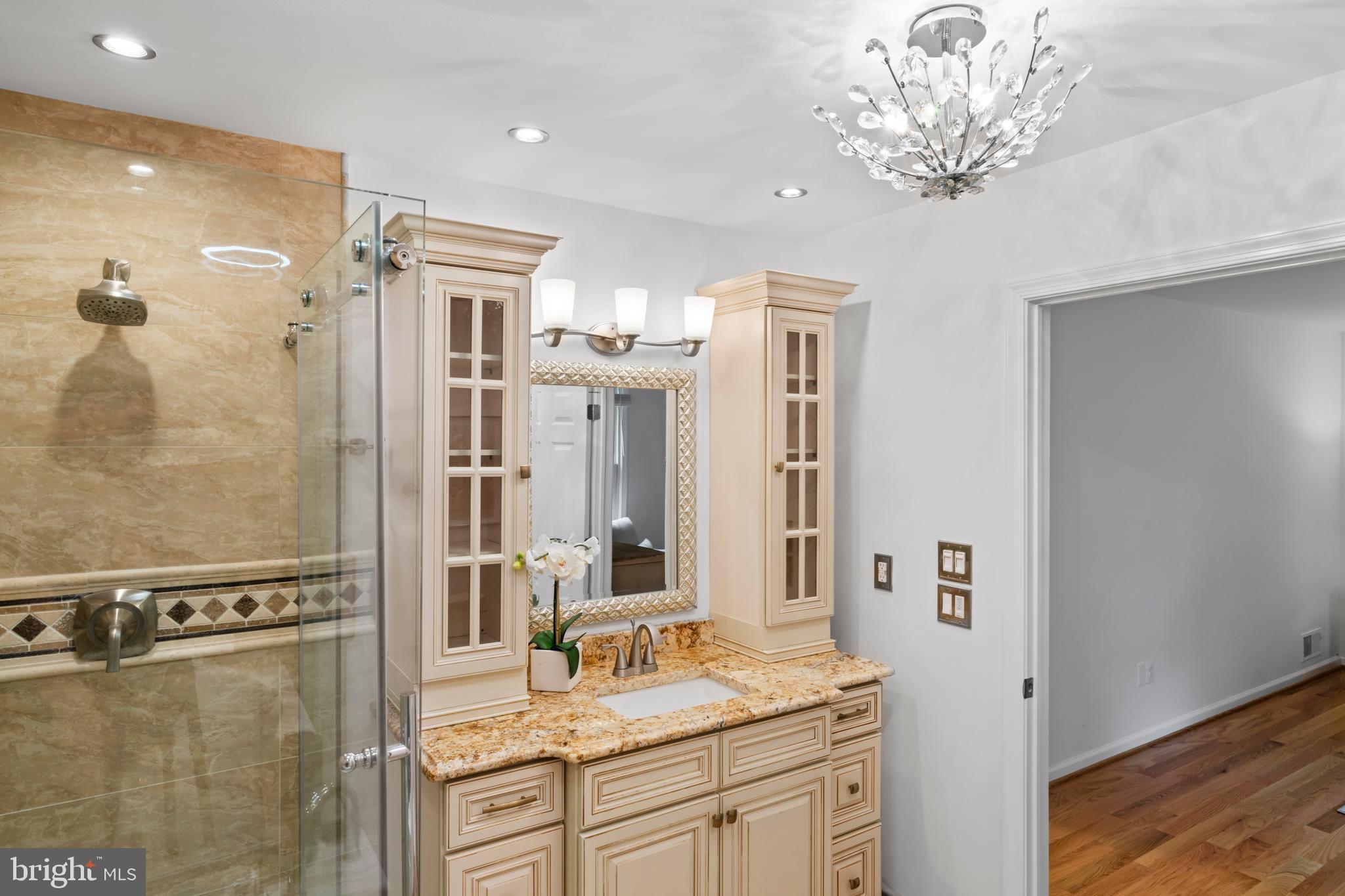 1950 Weybridge Lane Reston, VA 20191 - Photo 43 of 71 a bathroom with a granite countertop sink a mirror and a shower