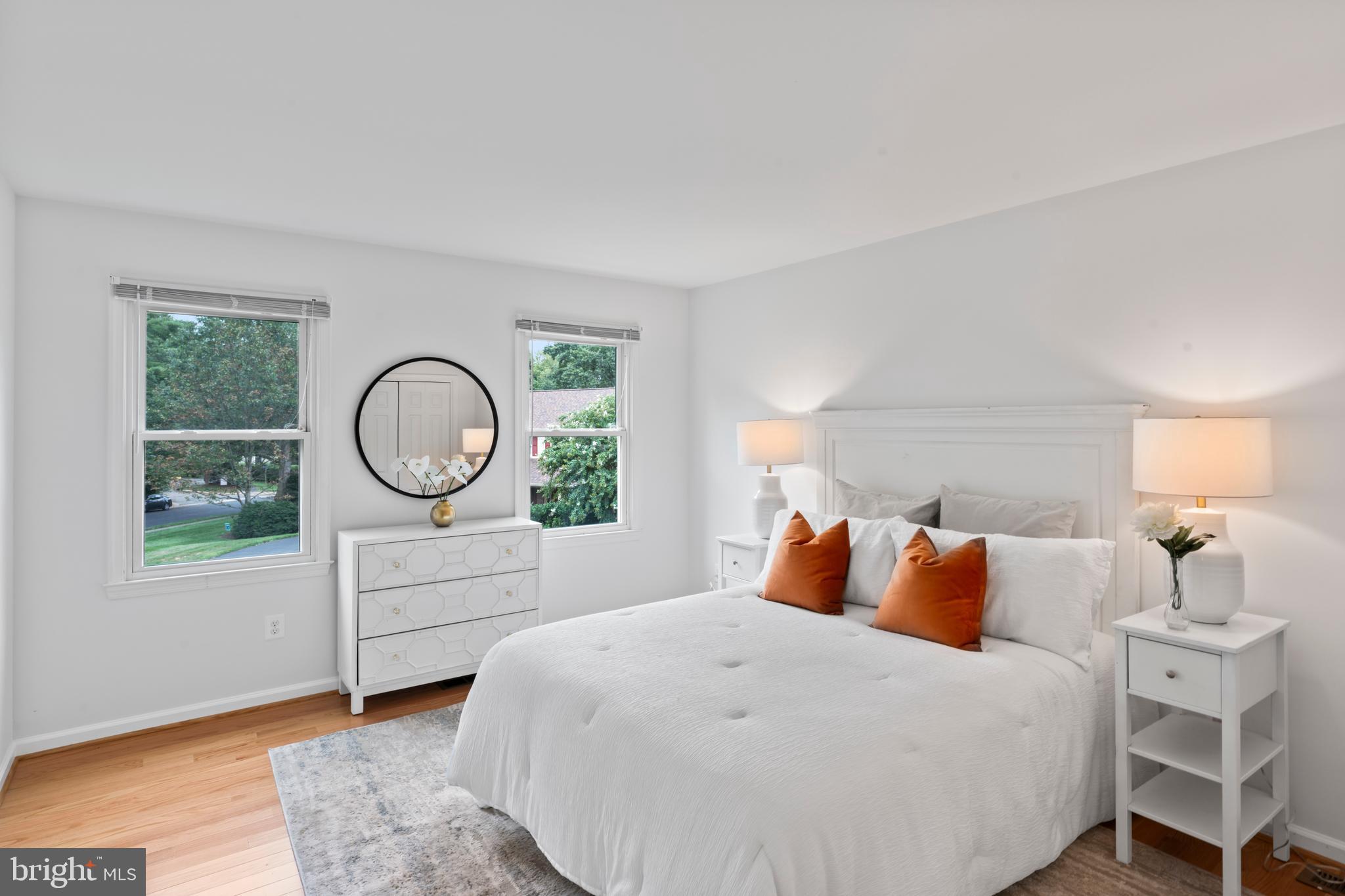 1950 Weybridge Lane Reston, VA 20191 - Photo 48 of 71 a bedroom with a large bed and wooden floor