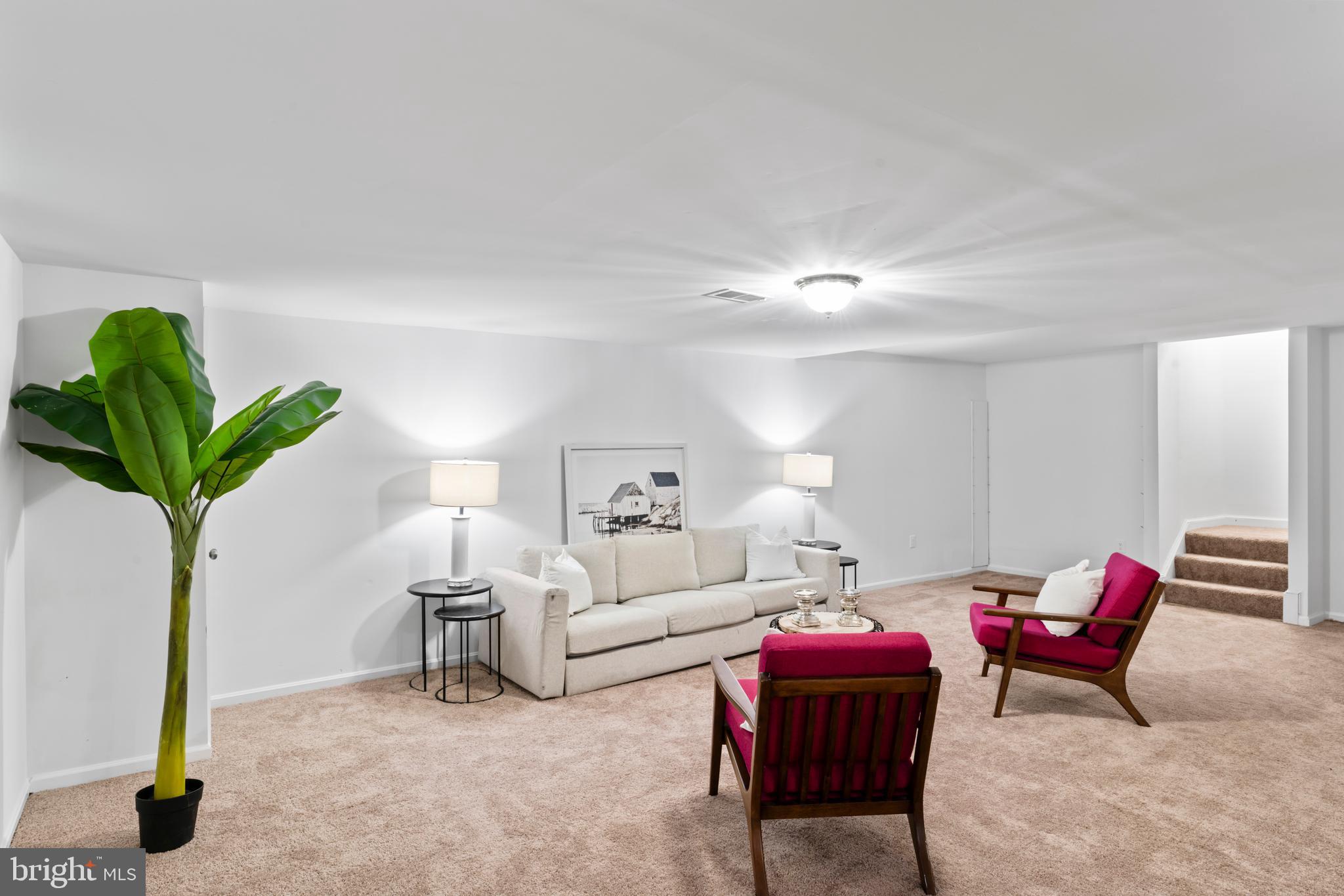 1950 Weybridge Lane Reston, VA 20191 - Photo 58 of 71 a living room with furniture a potted plant and a lamp