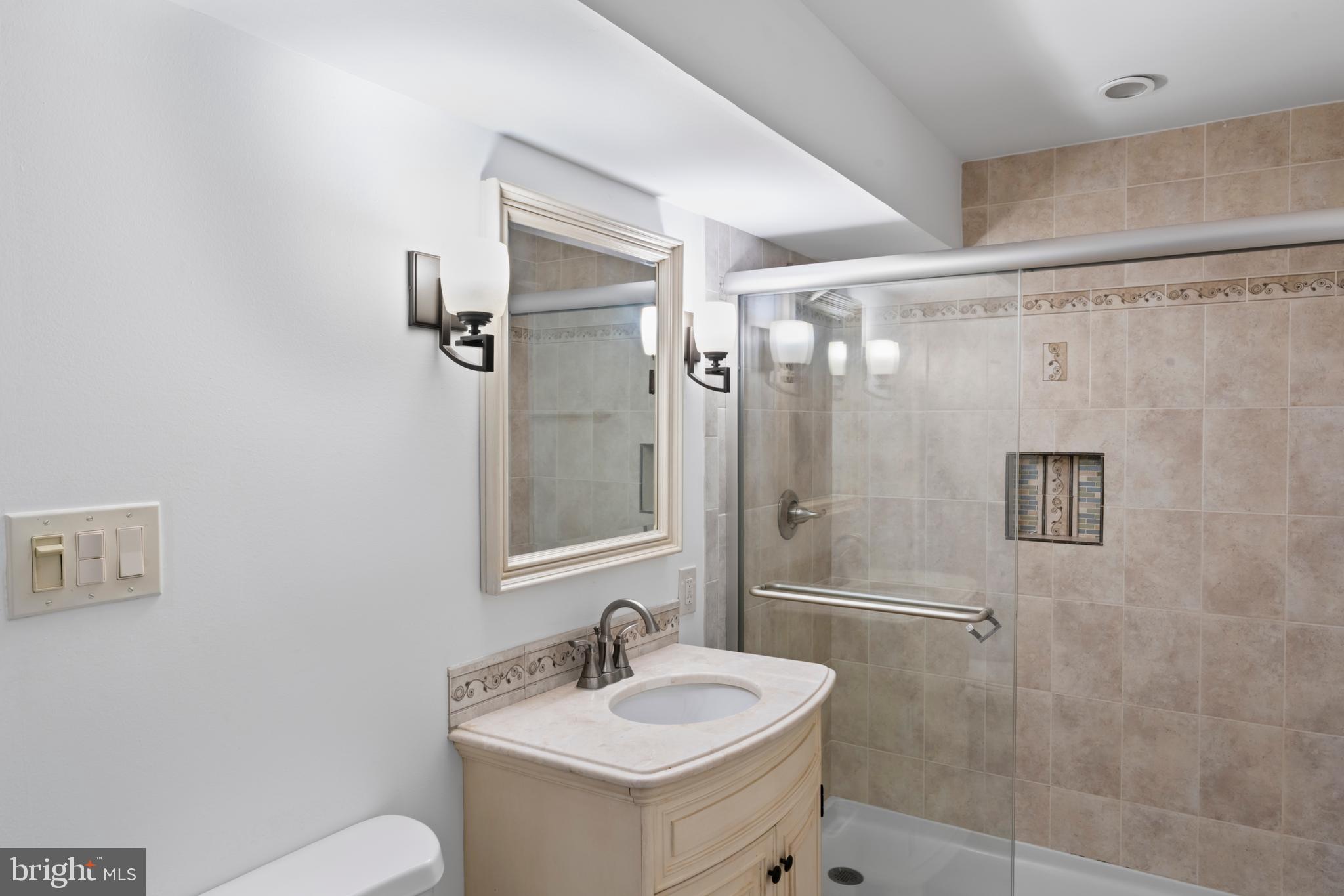 1950 Weybridge Lane Reston, VA 20191 - Photo 62 of 71 a bathroom with a sink mirror toilet and shower