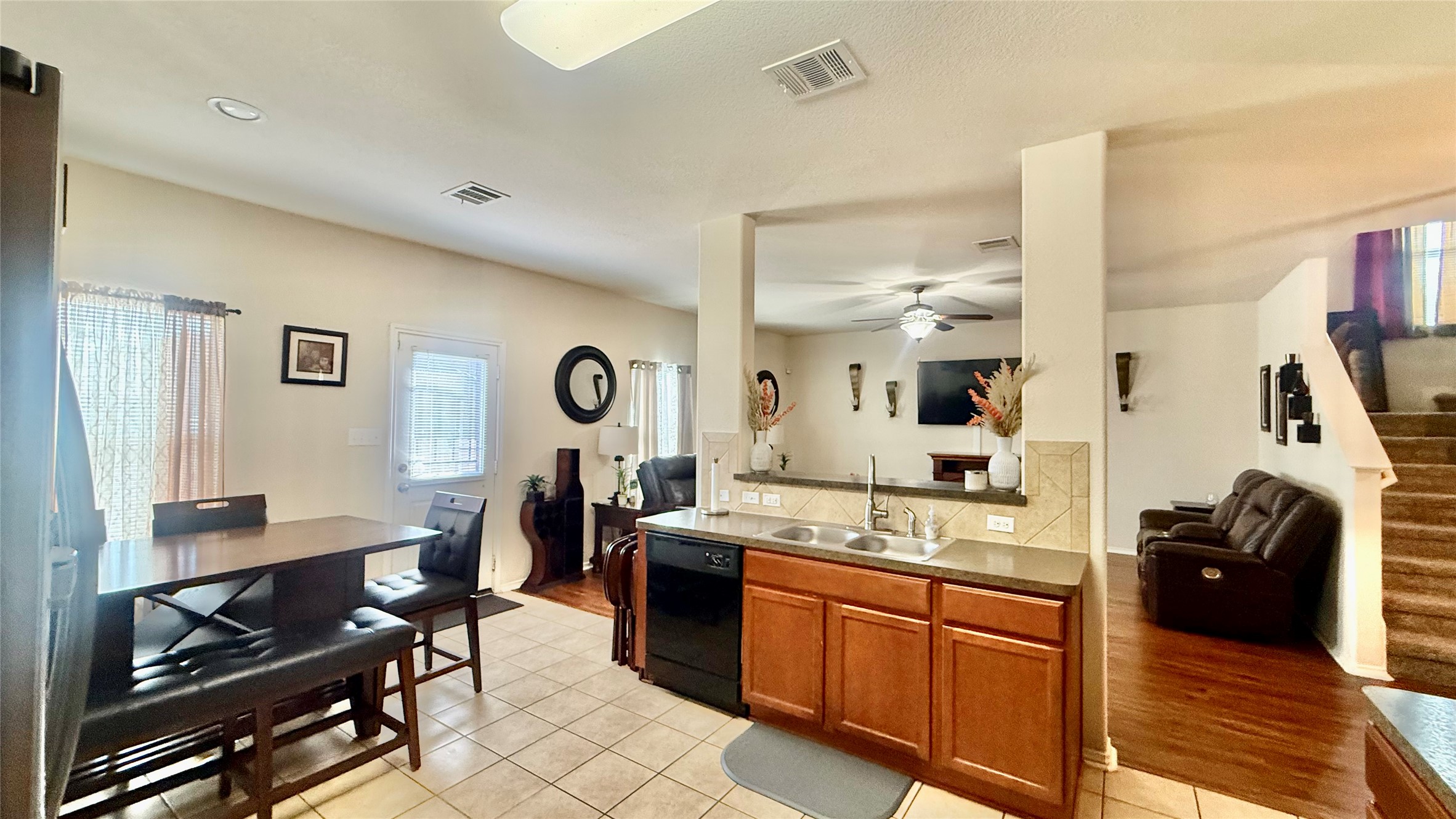 An open kitchen layout flows seamlessly into adjacent living and dining areas.