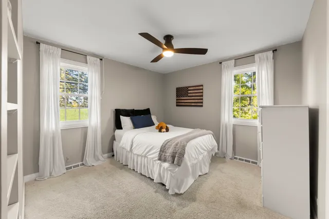 a bedroom with a bed and a window