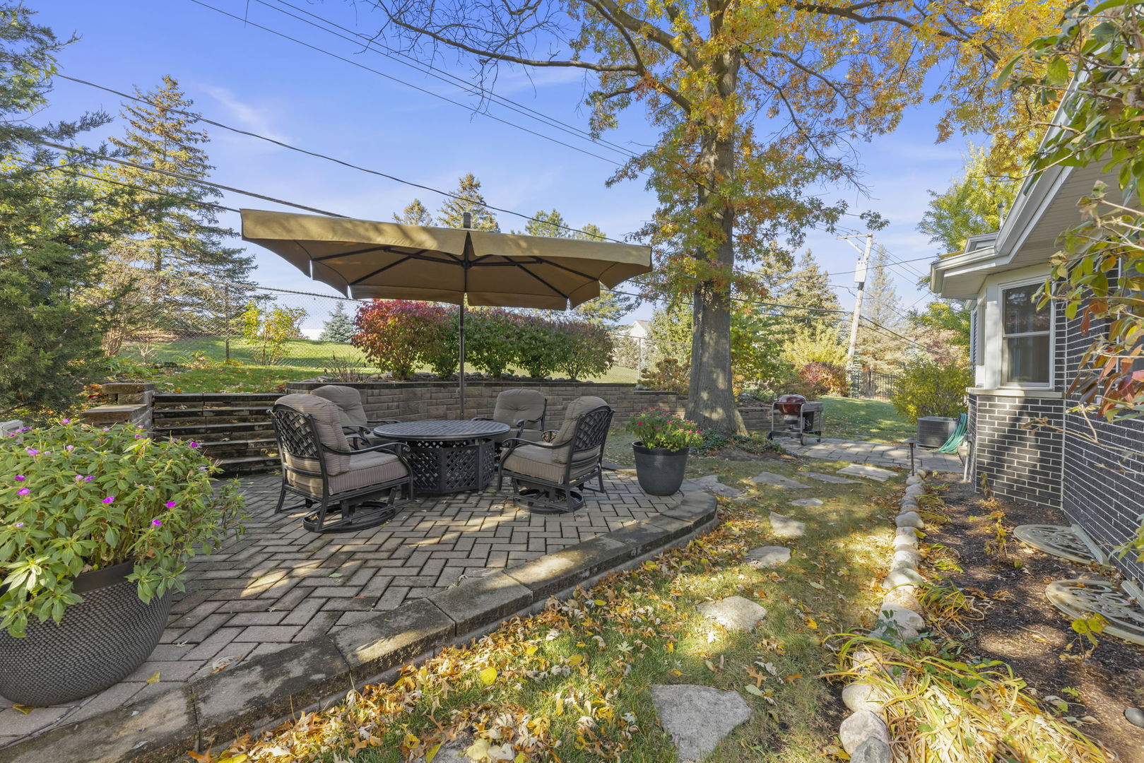 14340 Ridge Avenue Orland Park, IL 60462 - Photo 19 of 25 a view of a patio with a table and chairs under an umbrella