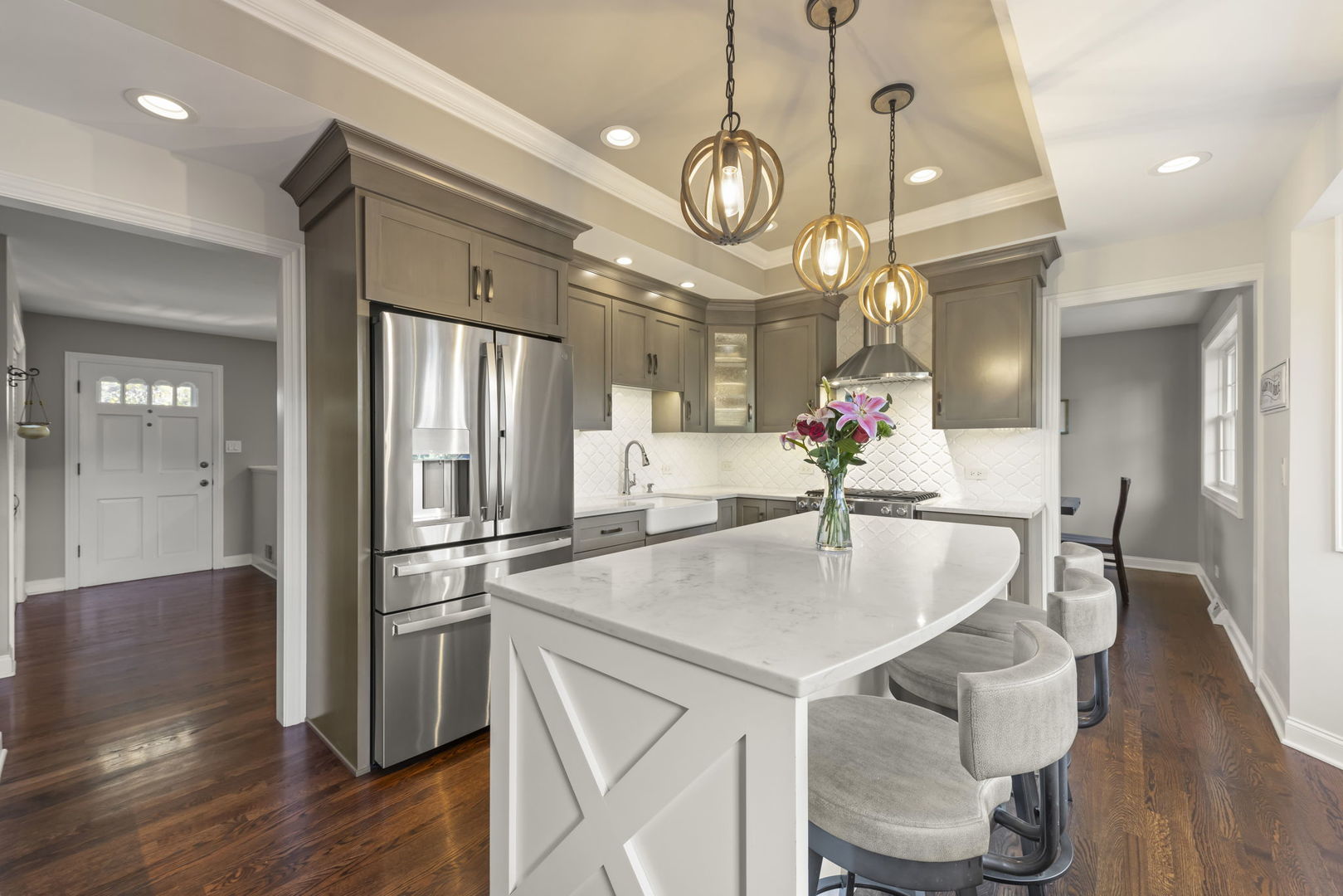 14340 Ridge Avenue Orland Park, IL 60462 - Photo 10 of 25 a kitchen with stainless steel appliances granite countertop a table chairs and chandelier