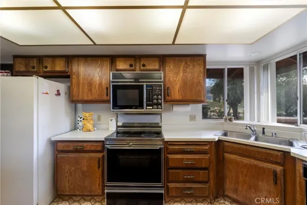 a view of a bedroom with wooden floor and furniture