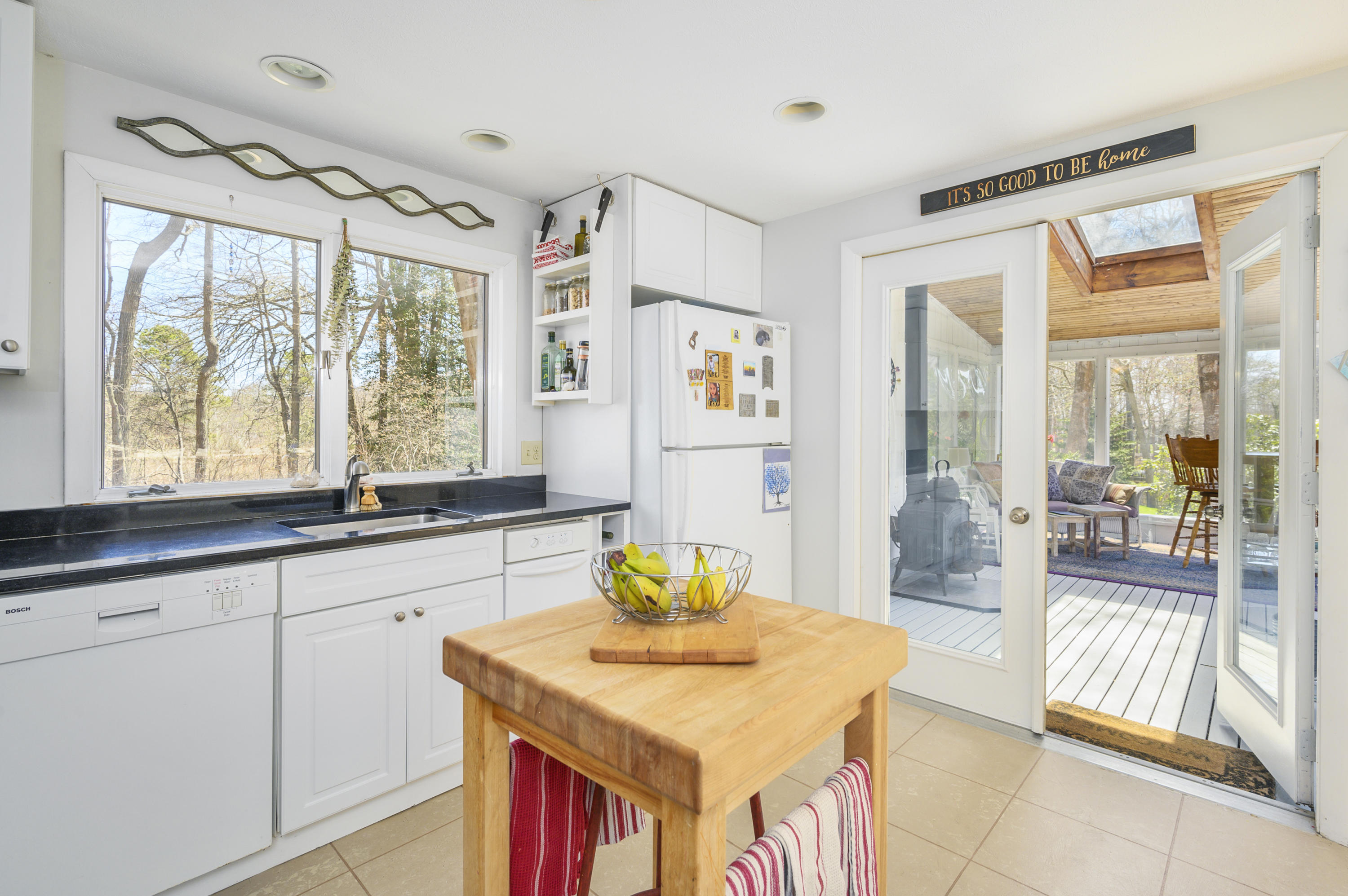 345 Holly Point Road Centerville, MA 02632 - Photo 12 of 28 a living room with stainless steel appliances granite countertop a sink a table and chairs