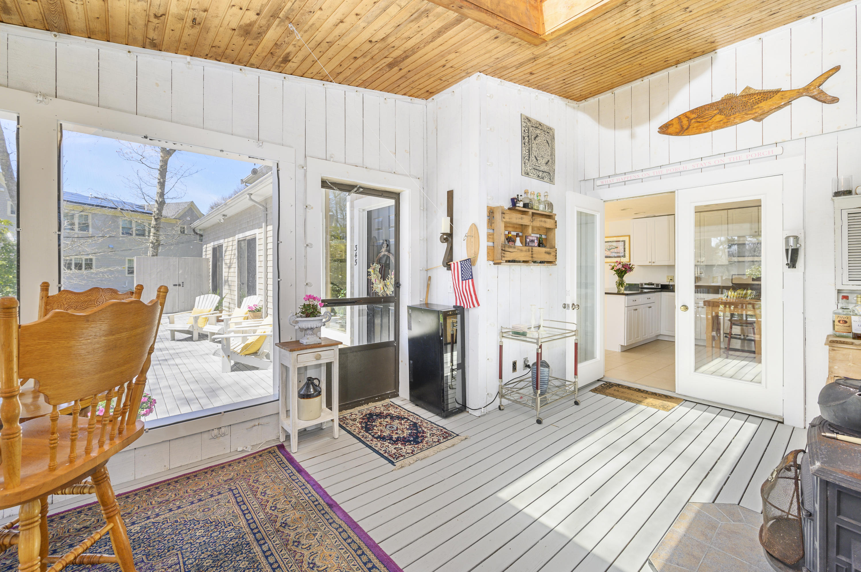 345 Holly Point Road Centerville, MA 02632 - Photo 16 of 28 a living room with furniture a wooden floor and next to a window