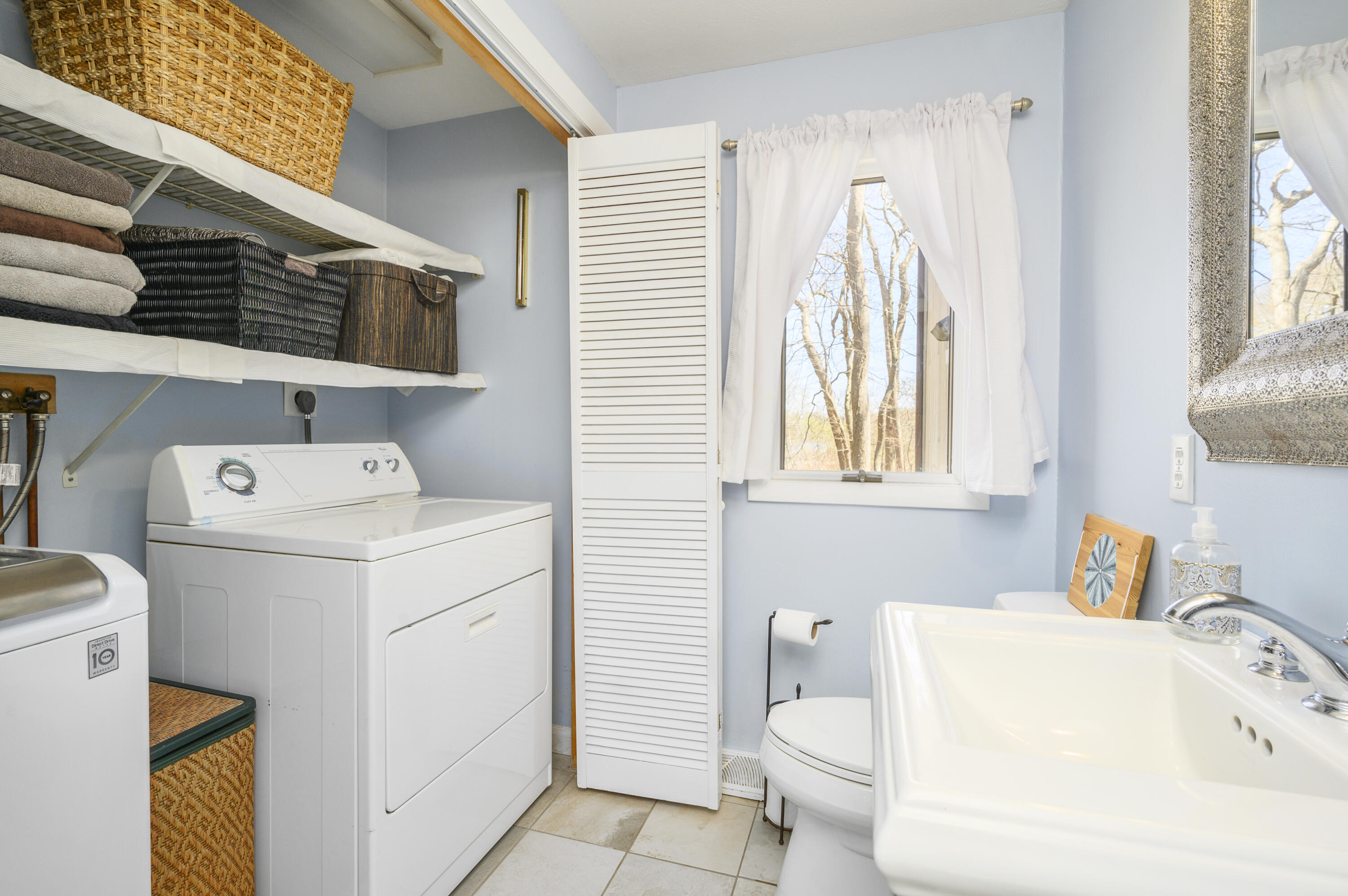 345 Holly Point Road Centerville, MA 02632 - Photo 18 of 28 a bathroom with a sink a toilet and a window