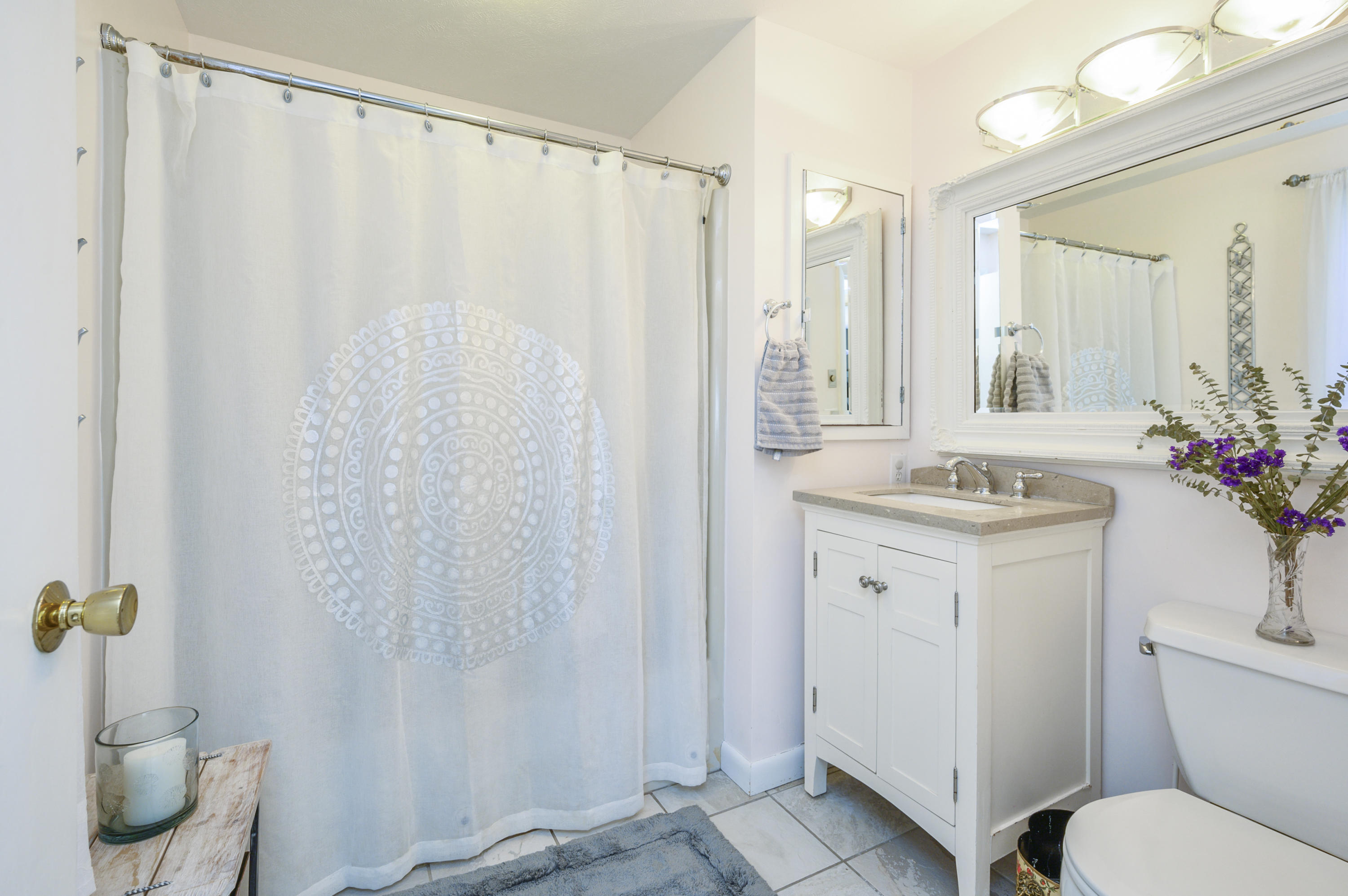 345 Holly Point Road Centerville, MA 02632 - Photo 23 of 28 a bathroom with a granite countertop sink and a mirror