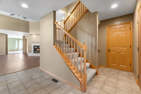 a view of entryway and hall with wooden floor
