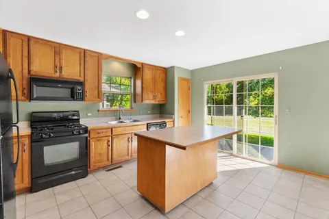 a kitchen that has a sink and a stove top oven