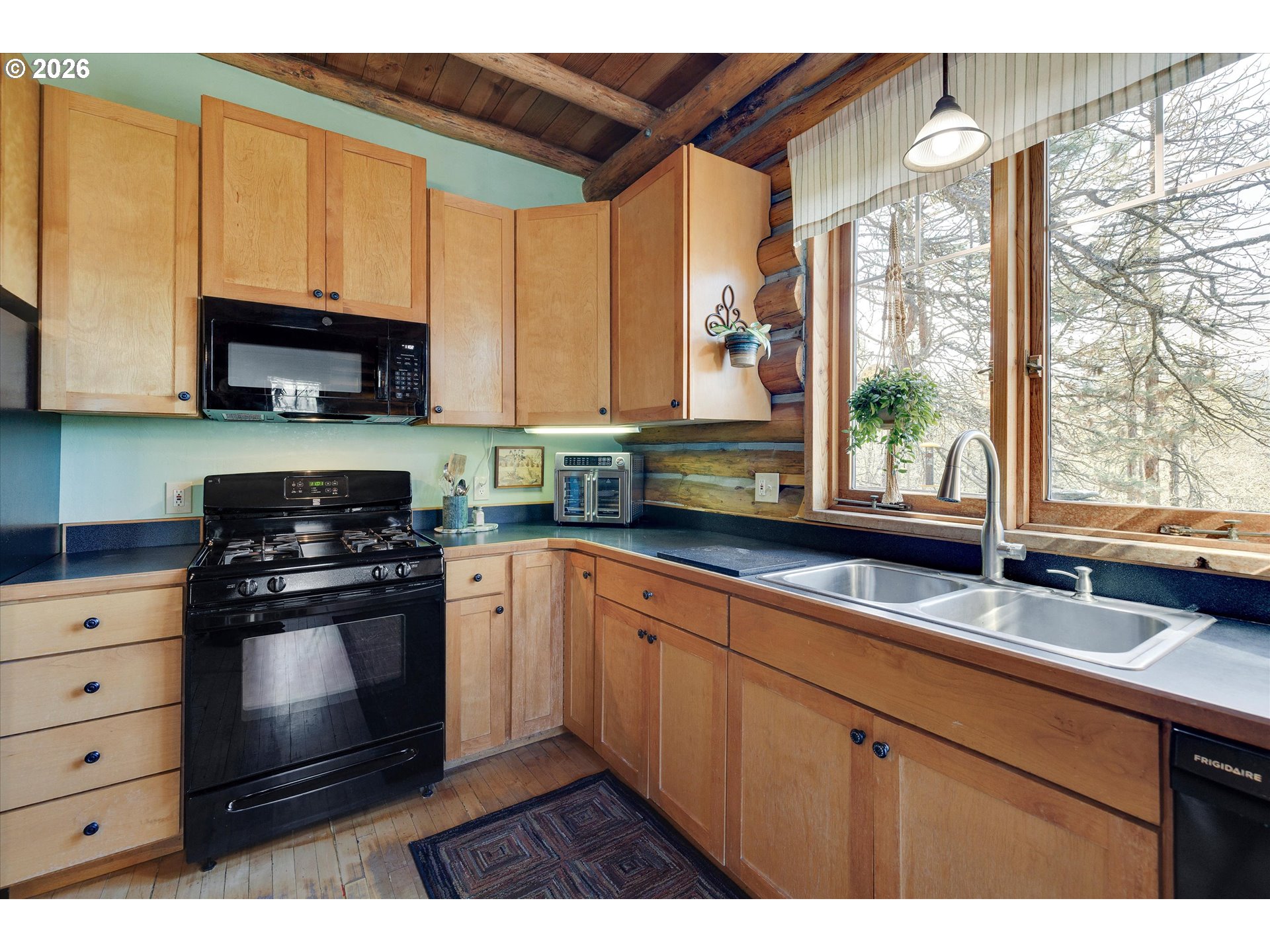 2215 Pine Oak Road Mosier, OR 97040 - Photo 27 of 46 a kitchen with stainless steel appliances a stove a sink and a microwave