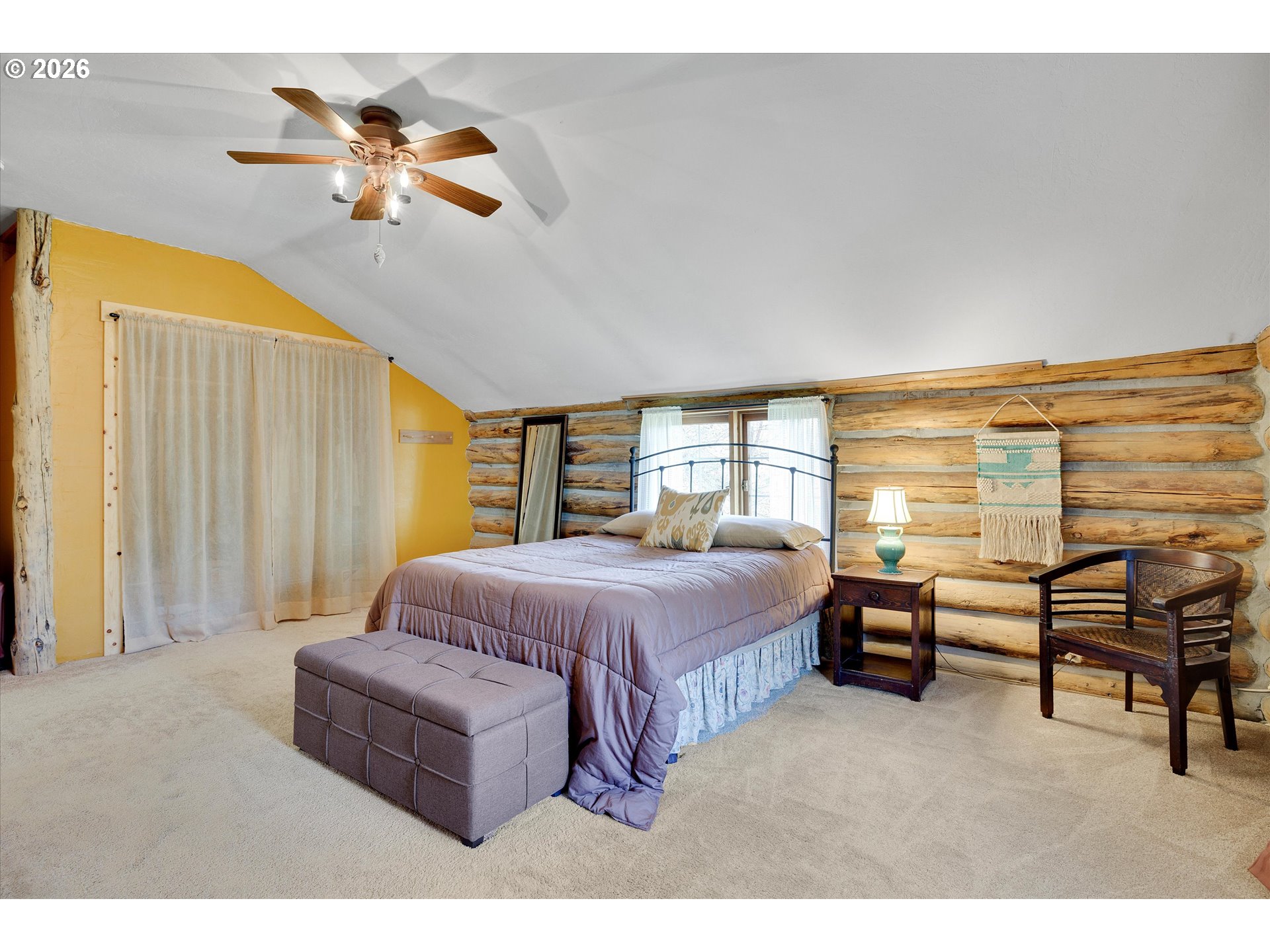 2215 Pine Oak Road Mosier, OR 97040 - Photo 43 of 46 a spacious bedroom with a bed and a chandelier