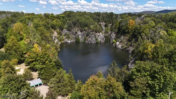 an aerial view of a houses with a yard