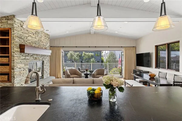 a living room with fireplace furniture and a chandelier