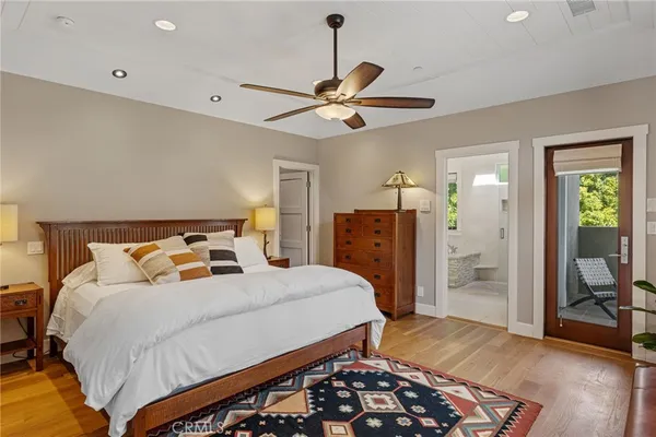 a bedroom with bed and wooden floor
