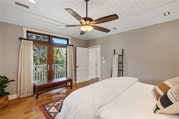 a bedroom with a large bed and a chandelier