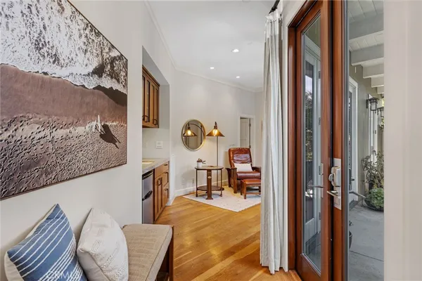 a living room with furniture a table and wooden floor