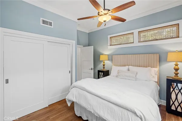a bedroom with a large bed and a chandelier