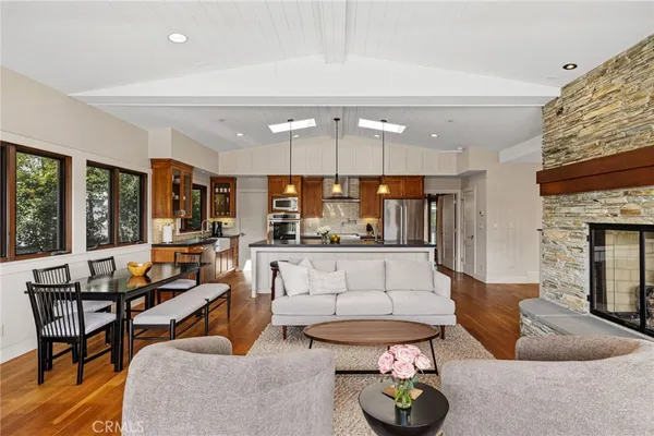 a living room with fireplace furniture and a large window