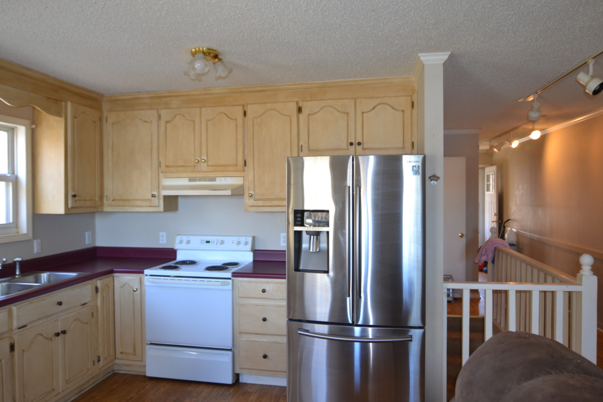 1283 Lake Logan Road Ardmore, TN 38449 - Photo 2 of 8 a kitchen with a refrigerator a sink and cabinets