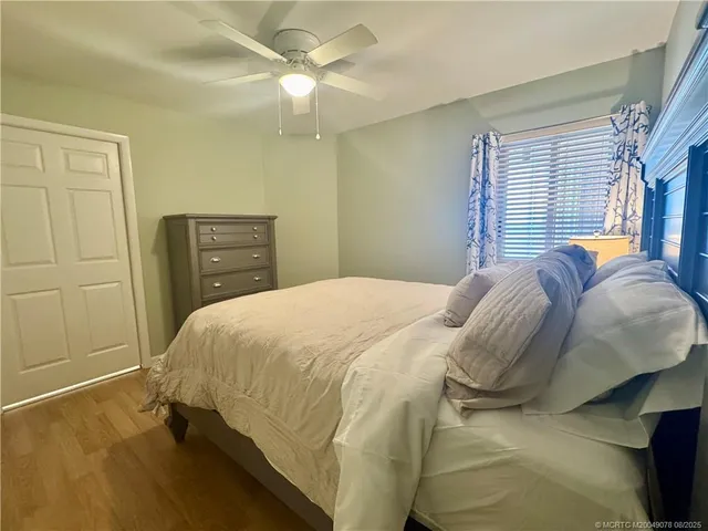 a spacious bedroom with a bed and a chandelier