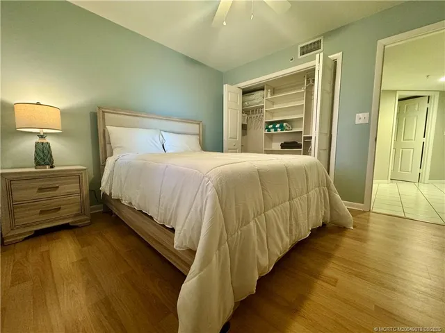 a bedroom with a bed and wooden floor