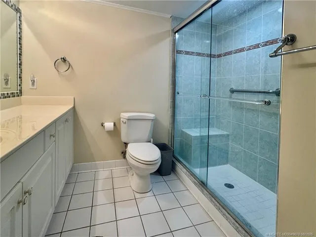 a bathroom with a shower a toilet and a sink