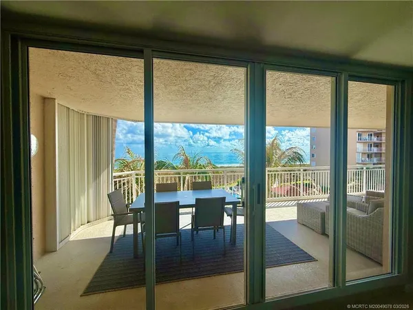 a view of a room with dining room and glass door