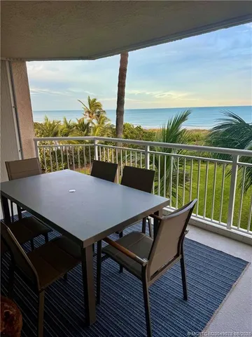 a view of a balcony with furniture
