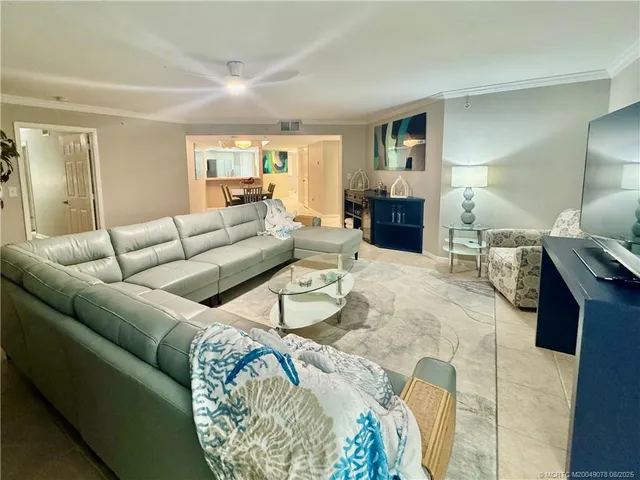 a living room with furniture and a lamp
