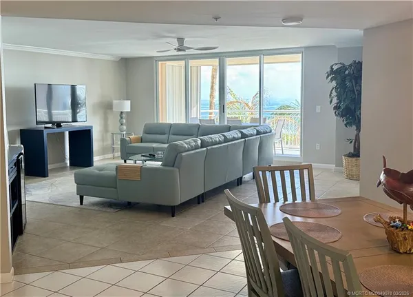 a living room with furniture and large windows