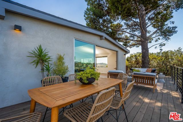 a living room with furniture and view of kitchen