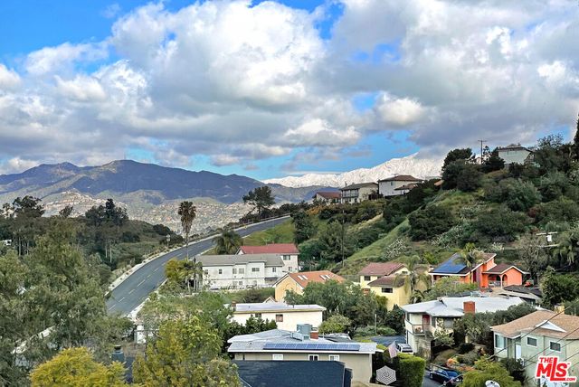a kitchen with stainless steel appliances kitchen island granite countertop a refrigerator a sink and a stove