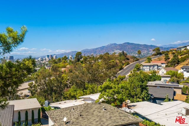 a kitchen with a sink stove top oven and cabinets