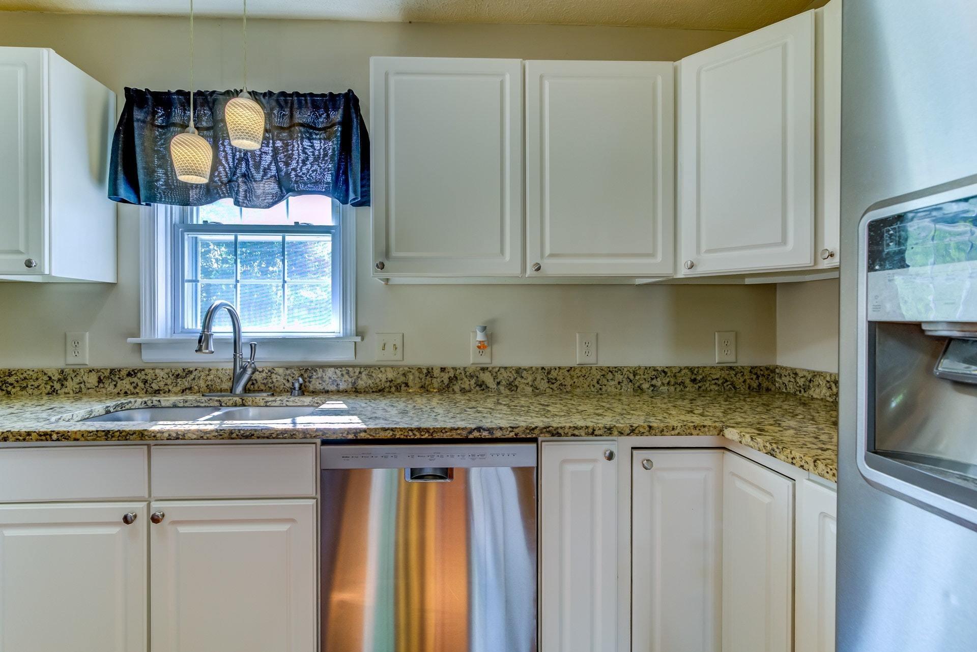 487 Olney Road Vinton, VA 24179 - Photo 12 of 54 a kitchen with stainless steel appliances granite countertop a sink and a white cabinets