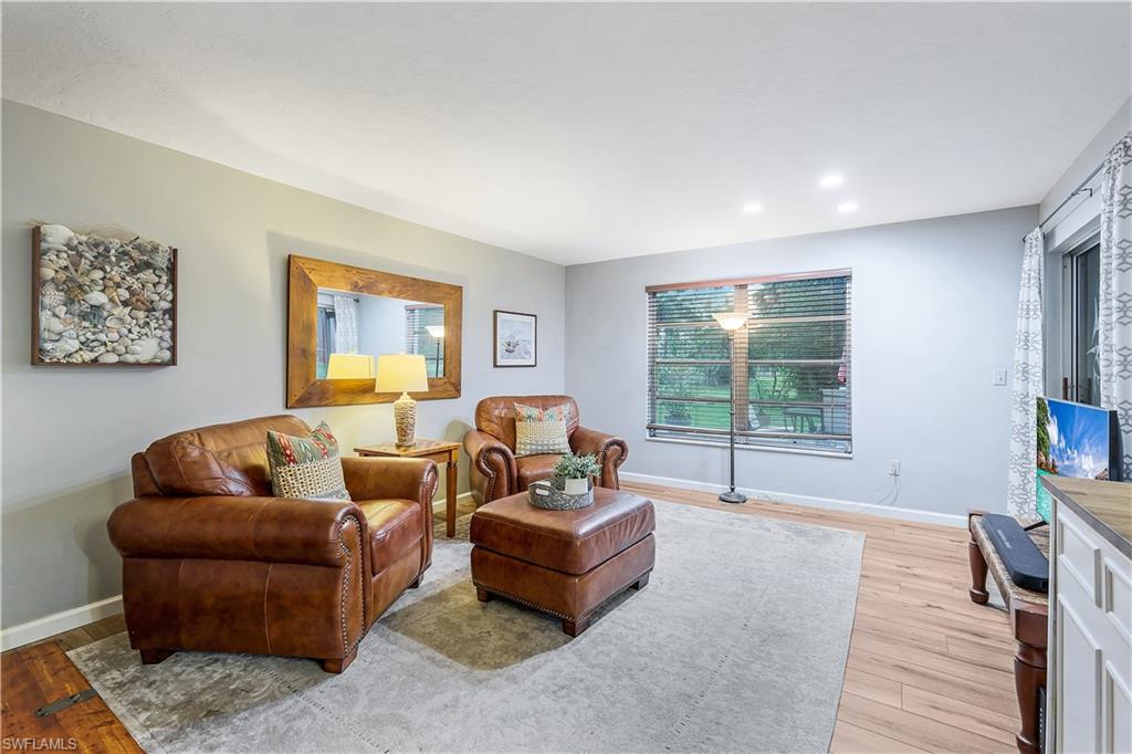 660 Pompano Drive Naples, FL 34110 - Photo 11 of 34 a living room with furniture and a flat screen tv