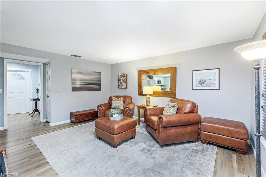 660 Pompano Drive Naples, FL 34110 - Photo 12 of 34 a living room with furniture and a wooden floor