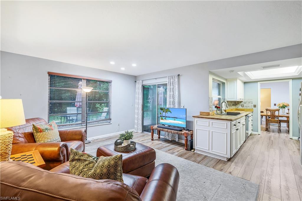 660 Pompano Drive Naples, FL 34110 - Photo 13 of 34 a living room with furniture and a table