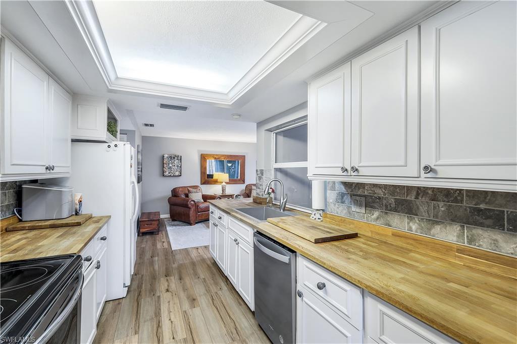 660 Pompano Drive Naples, FL 34110 - Photo 17 of 34 a kitchen with a sink and cabinets