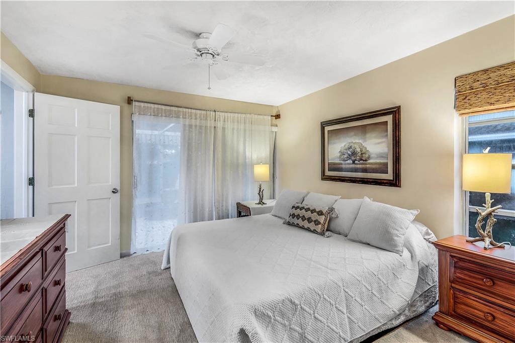 660 Pompano Drive Naples, FL 34110 - Photo 19 of 34 a bedroom with a bed and a lamp on dresser