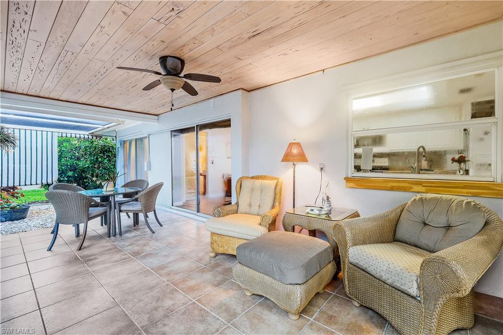 660 Pompano Drive Naples, FL 34110 - Photo 4 of 34 a living room with furniture and a large window