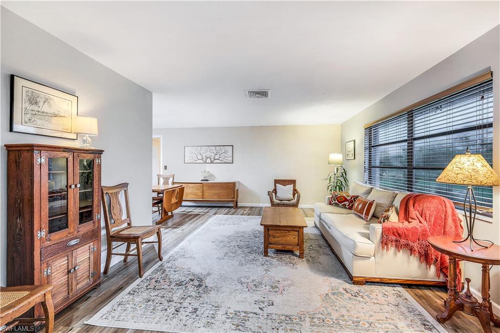 660 Pompano Drive Naples, FL 34110 - Photo 6 of 34 a living room with furniture and a wooden floor