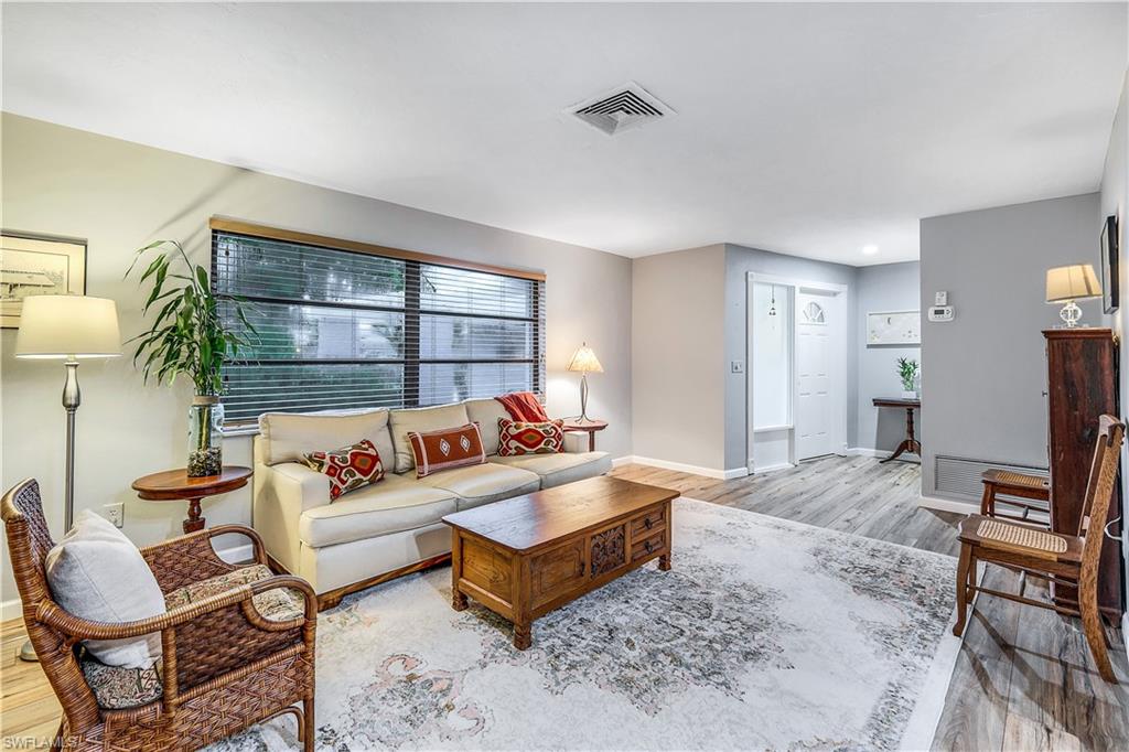 660 Pompano Drive Naples, FL 34110 - Photo 8 of 34 a living room with furniture and a table