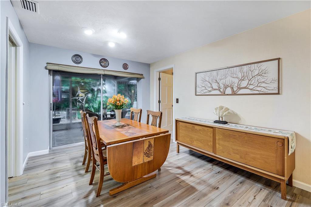 660 Pompano Drive Naples, FL 34110 - Photo 10 of 34 a living room with stainless steel appliances granite countertop furniture and wooden floor